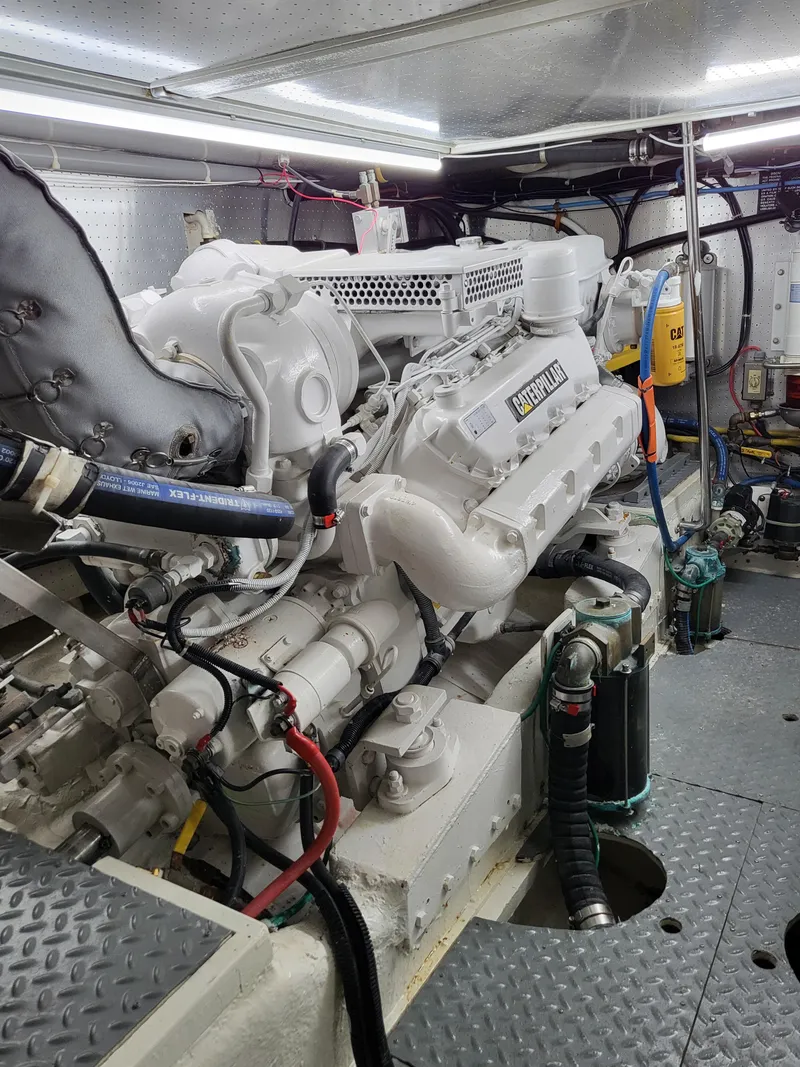Slide: The Image of Engine room of a 1997 McKinna 48' Pilot House yacht, showcasing mechanical components. - 28