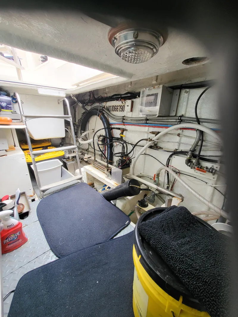 Slide: The Image of Engine room of 1997 McKinna 48' Pilot House with visible wiring and equipment. - 30