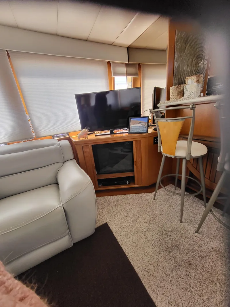 Slide: The Image of Interior of 1997 McKinna 48' Pilot House with TV, sofa, and bar stool. - 9