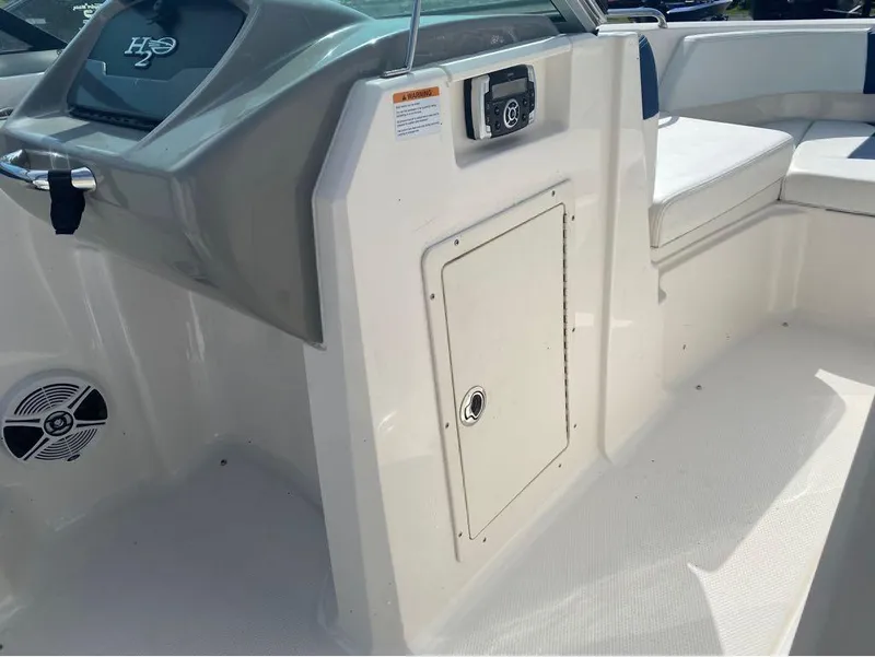 Slide: The Image of 2018 Chaparral 21 H2O Sport boat interior with seating and storage compartment. - 12