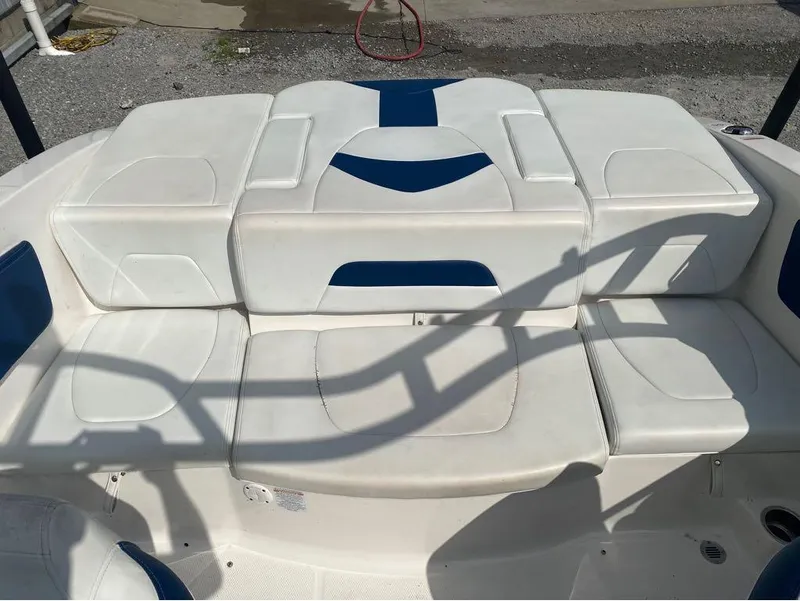 Slide: The Image of 2018 Chaparral 21 H2O Sport boat interior with white and blue seating. - 14
