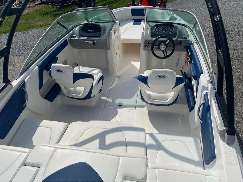 Slide: The Image of 2018 Chaparral 21 H2O Sport boat interior with white and blue seating. - 15