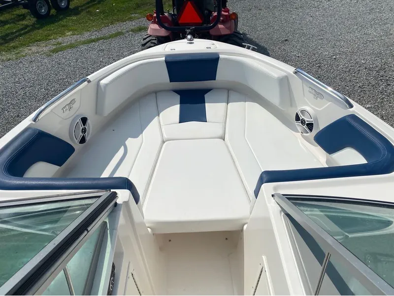 Slide: The Image of 2018 Chaparral 21 H2O Sport boat interior with blue and white seating. - 16