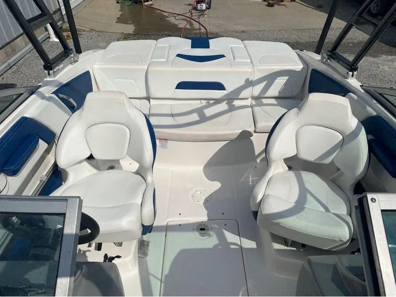 Slide: The Image of 2018 Chaparral 21 H2O Sport boat interior with white seating and blue accents. - 17