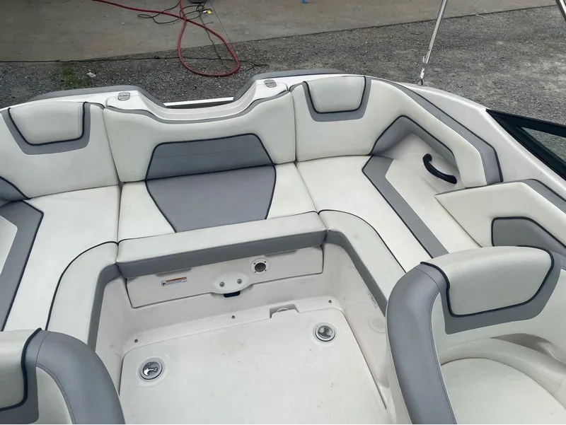 Slide: The Image of 2017 Yamaha Boats SX190 interior with white and gray seating, showcasing spacious design. - 12