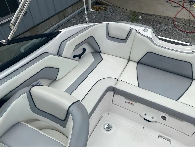 Slide: The Image of 2017 Yamaha Boats SX190 interior with white and gray seating, modern design. - 15