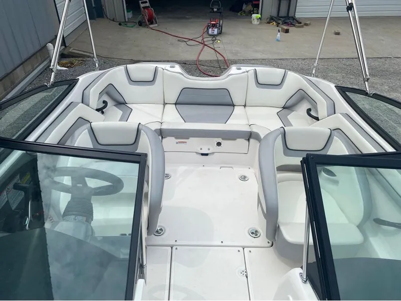 Slide: The Image of 2017 Yamaha Boats SX190 interior with white and gray seating, steering wheel, and open windshield. - 3