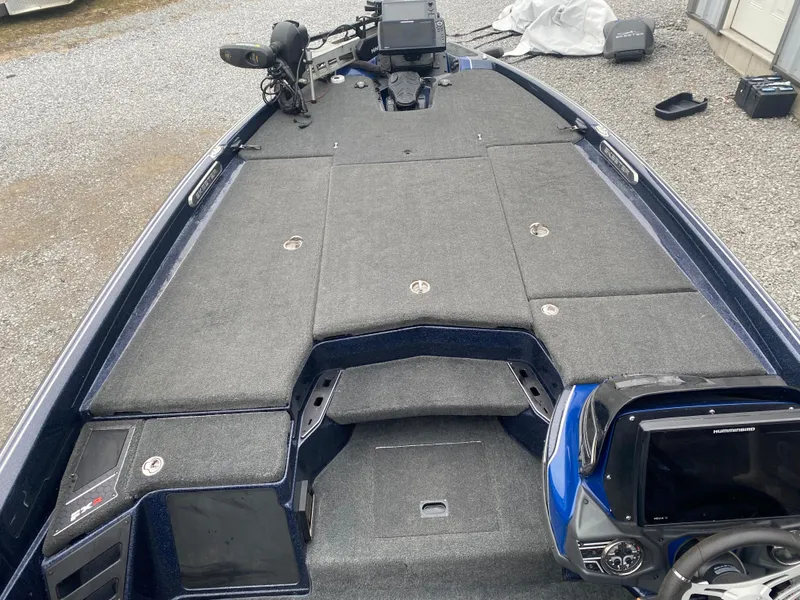 Slide: The Image of 2020 Skeeter FXR20 Limited boat interior with gray carpet and advanced navigation system. - 12