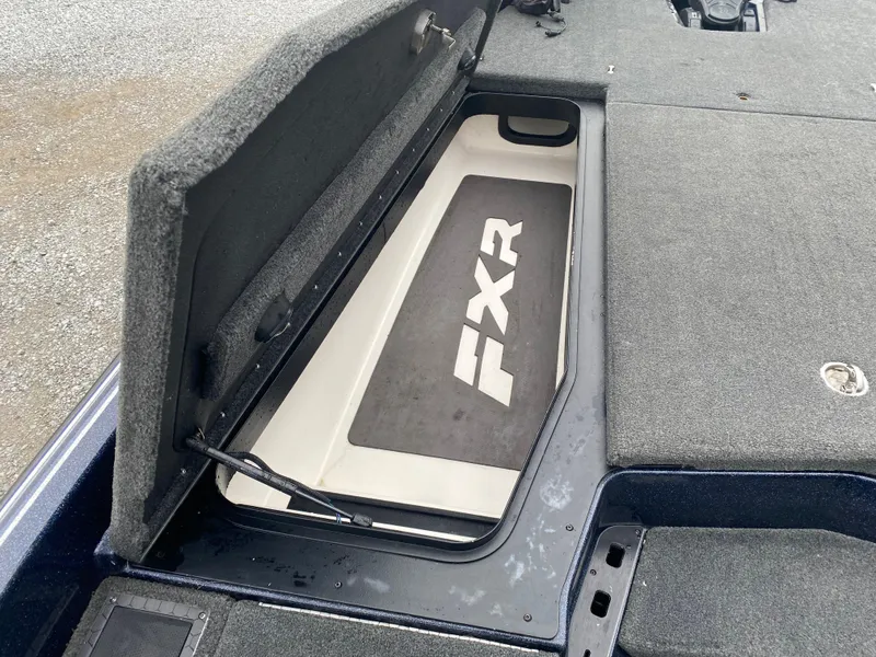 Slide: The Image of Open storage compartment on a 2020 Skeeter FXR20 Limited boat, featuring "FXR" branding. - 14