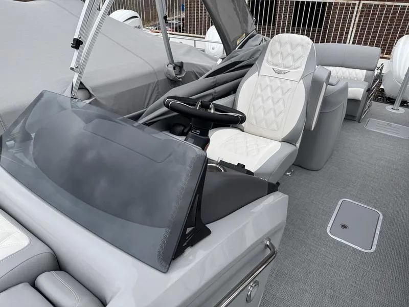Slide: The Image of 2025 Bennington 25 QFBA boat interior with sleek helm and luxurious seating. - 12