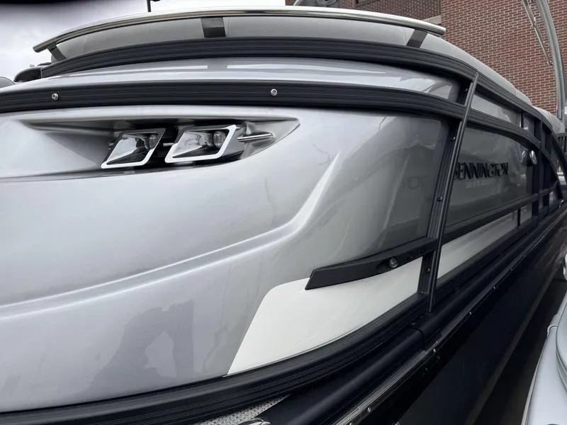 Slide: The Image of 2025 Bennington 25 QFBA pontoon boat with sleek silver design and modern features. - 15