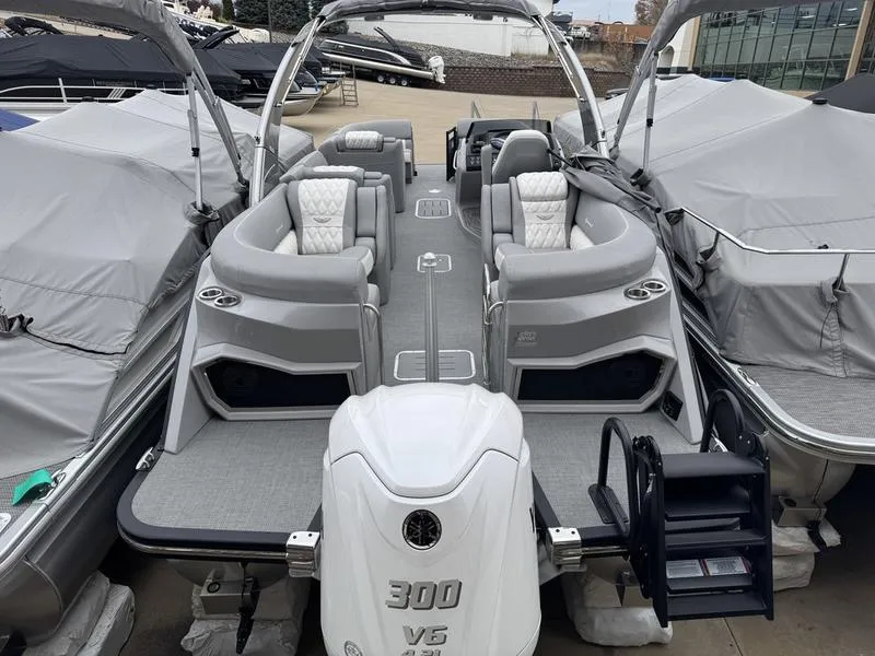 Slide: The Image of 2025 Bennington 25 QFBA pontoon boat with Yamaha 300 V6 engine, docked and covered. - 3