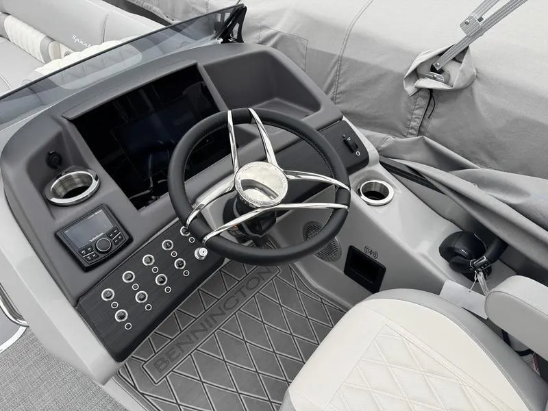 Slide: The Image of 2025 Bennington 25 QFBA boat dashboard with steering wheel and control panel. - 7