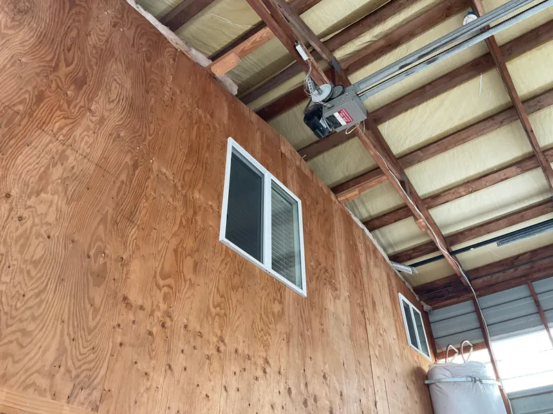 Slide: The Image of Wooden interior of a 1987 custom boathouse with windows and exposed beams. - 12