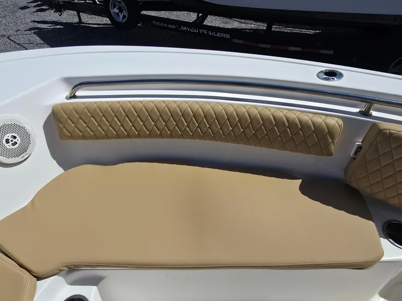 Slide: The Image of 2016 Tidewater 210 LXF boat interior with tan cushioned seating and stainless steel railing. - 10