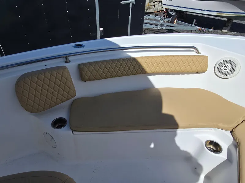 Slide: The Image of 2016 Tidewater 210 LXF boat interior with tan cushioned seating and stainless steel cup holders. - 11