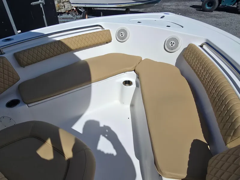 Slide: The Image of 2016 Tidewater 210 LXF boat interior with tan cushioned seating and cup holders. - 13