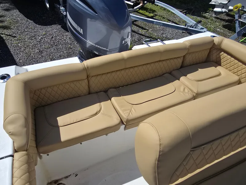 Slide: The Image of 2016 Tidewater 210 LXF boat with tan cushioned seating and Yamaha outboard motor. - 14