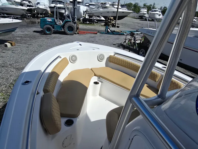 Slide: The Image of 2016 Tidewater 210 LXF boat with tan seating, docked in a marina. - 9