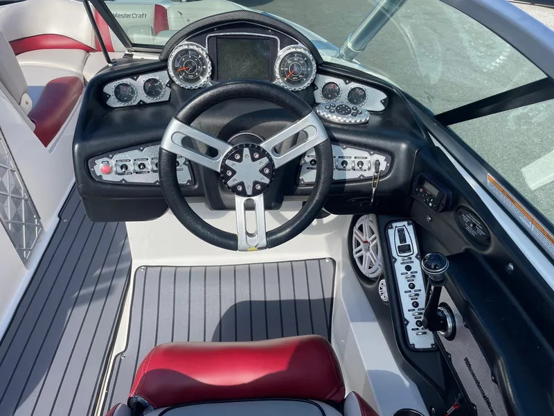 Slide: The Image of 2010 MasterCraft X-25 boat dashboard with steering wheel and control panel. - 3