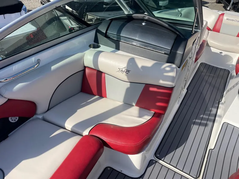Slide: The Image of 2010 MasterCraft X-25 boat interior with red and white seating and sleek design. - 4