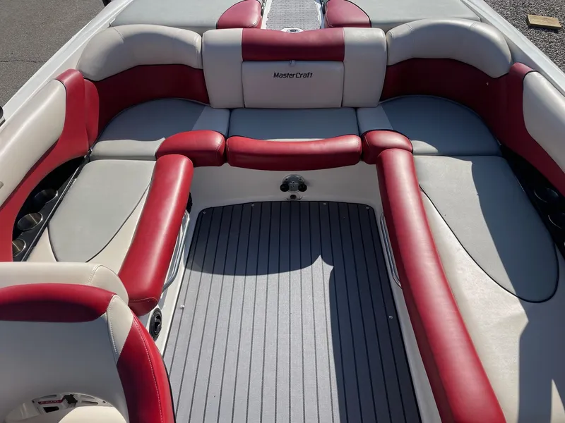 Slide: The Image of 2010 MasterCraft X-25 boat interior with red and gray seating. - 5