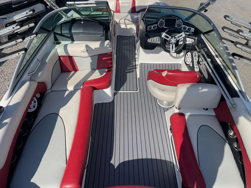 Slide: The Image of 2010 MasterCraft X-25 boat interior with red and white seating, sleek dashboard, and modern design. - 6