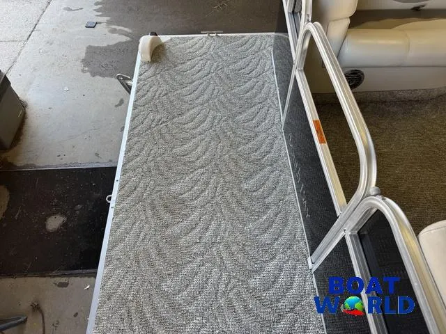 Slide: The Image of 2008 South Bay 20' Cruise Pontoon deck with patterned flooring, featuring Boat World logo. - 11