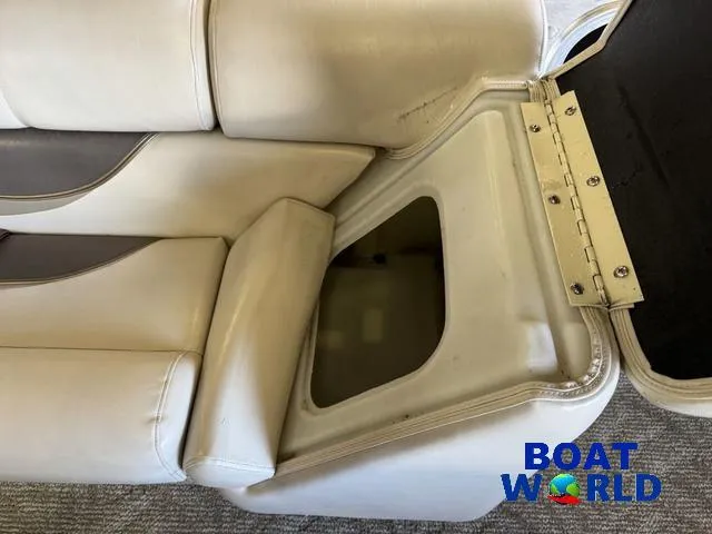 Slide: The Image of 2008 South Bay pontoon boat seat storage compartment, open with visible interior. - 16