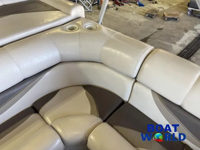Slide: The Image of Luxurious seating on 2008 South Bay 20' Cruise Pontoon with cup holders, in a garage setting. - 18