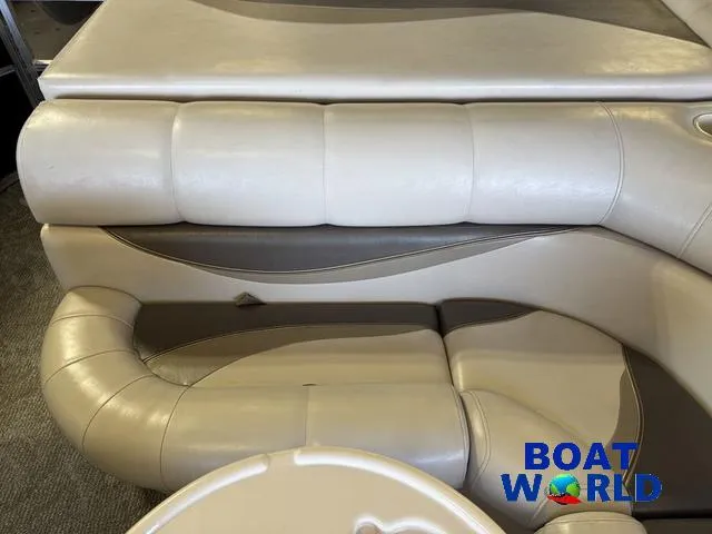 Slide: The Image of 2008 South Bay 20' Cruise Pontoon interior seating, featuring beige upholstery and Boat World logo. - 19
