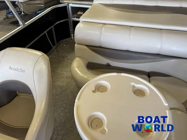 Slide: The Image of 2008 South Bay 20' Cruise Pontoon interior with seating and table, featuring Boat World logo. - 20