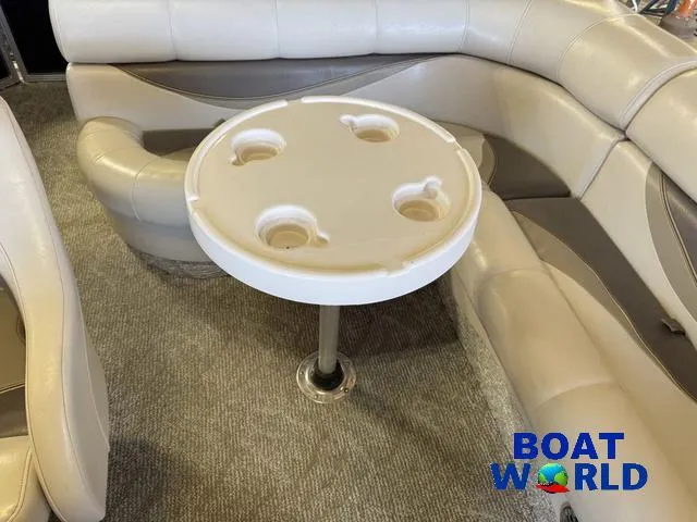 Slide: The Image of 2008 South Bay 20' Cruise Pontoon interior with round table and cushioned seating. - 22