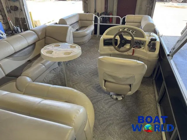 Slide: The Image of 2008 South Bay 20' Cruise Pontoon interior with plush seating and steering console. - 3