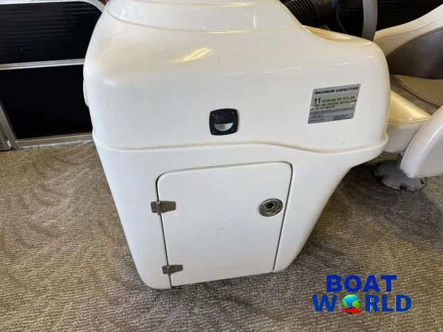Slide: The Image of 2008 South Bay 20' Cruise Pontoon console with storage compartment and capacity label. - 32