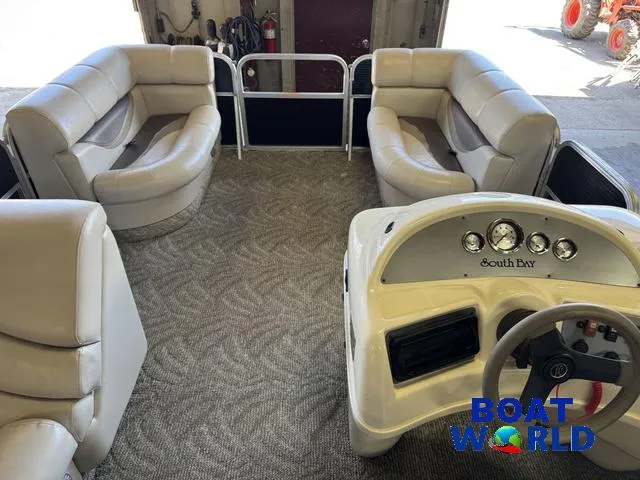 Slide: The Image of 2008 South Bay 20' Cruise Pontoon interior with plush seating and steering console. - 4