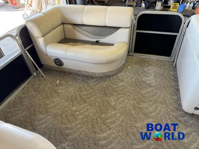 Slide: The Image of 2008 South Bay 20' Cruise Pontoon interior with beige seating and carpeted floor. - 7