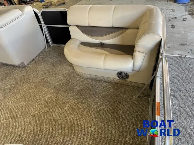 Slide: The Image of 2008 South Bay 20' Cruise Pontoon interior with beige seating and carpet flooring. - 9