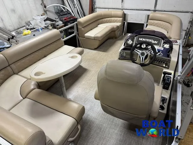 Slide: The Image of 2019 Montego Bay 8518 Cruise interior with beige seating and steering console. - 10