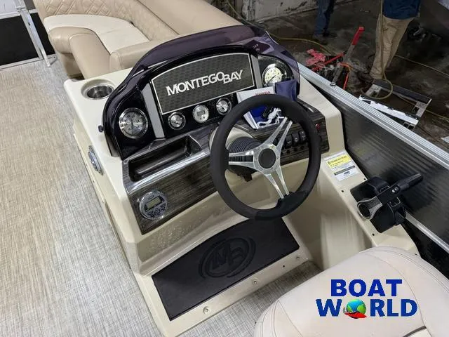 Slide: The Image of 2019 Montego Bay 8518 Cruise boat dashboard with steering wheel and controls, featuring Honda 60HP engine. - 9