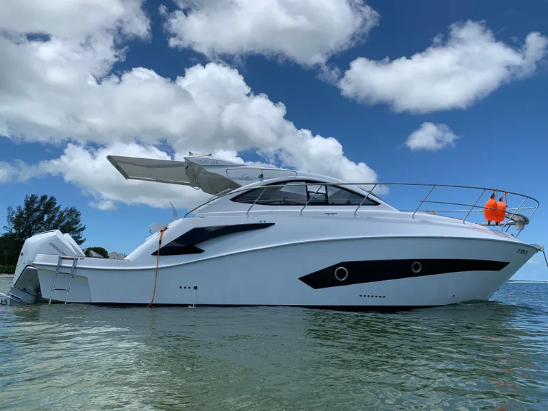 Slide: The Image of 2022 Evolve 360HT yacht on water under blue sky with clouds. - 14