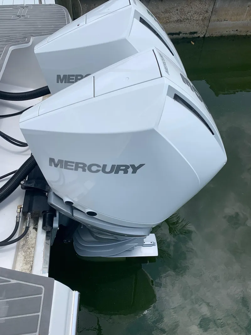 Slide: The Image of Twin Mercury outboard engines on a 2022 Evolve 360HT boat. - 2