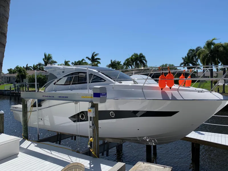 Slide: The Image of Evolve 360HT 2022 yacht docked, surrounded by palm trees and clear blue sky. - 25