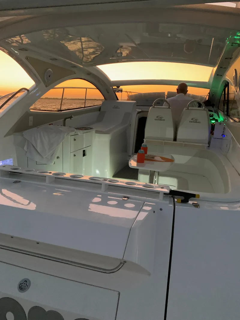 Slide: The Image of Luxury Evolve 360HT yacht interior at sunset, 2022 model, with elegant seating and ocean view. - 31