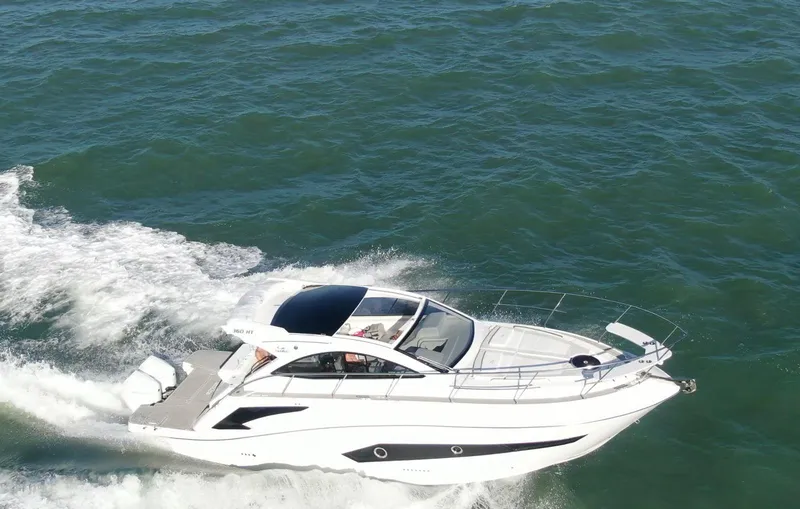 Slide: The Image of 2022 Evolve 360HT yacht cruising on open water, showcasing sleek design and performance. - 32