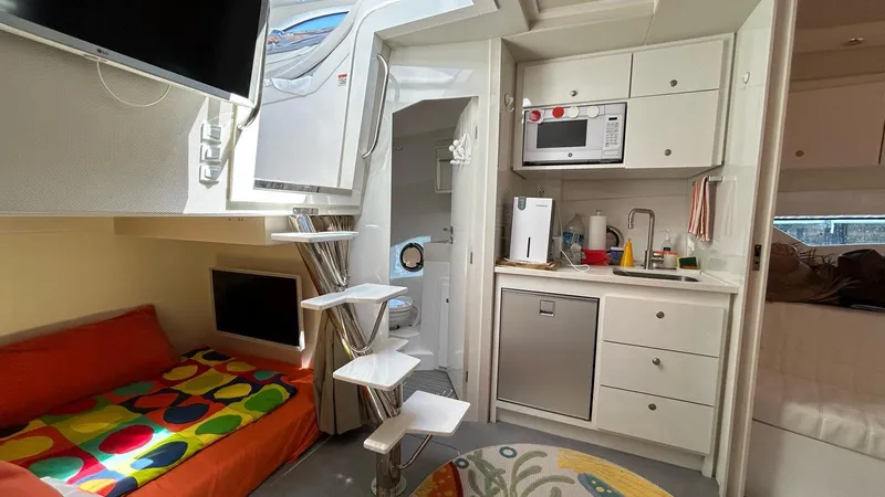 Slide: The Image of Modern 2022 Evolve 360HT yacht interior with kitchenette, colorful seating, and compact design. - 42