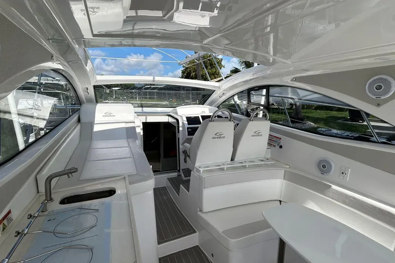 Slide: The Image of Interior of 2021 Evolve 360HT yacht, featuring sleek white seating and modern design elements. - 59