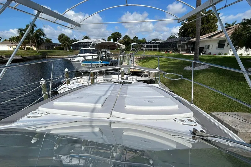 Slide: The Image of Evolve 360HT 2021 yacht docked by a canal with lush greenery and clear skies. - 61