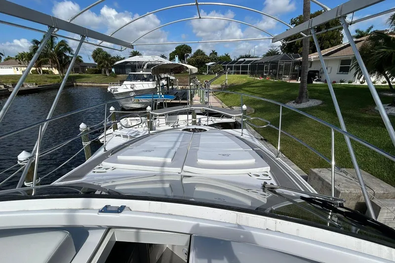 Slide: The Image of Evolve 360HT 2021 yacht docked by a canal, surrounded by lush greenery and clear skies. - 62