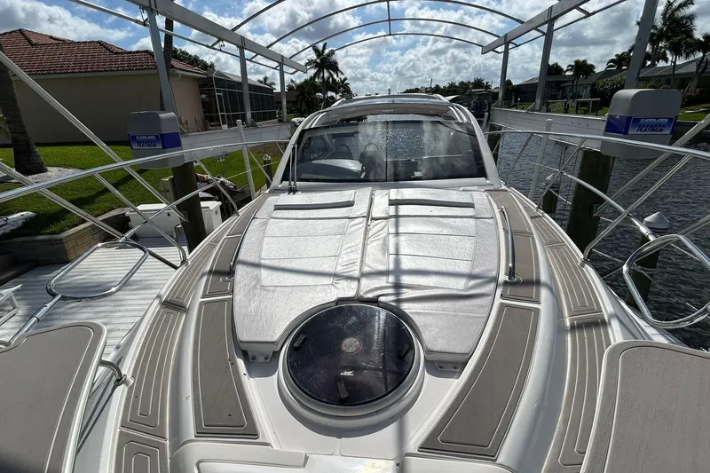 Slide: The Image of Luxury Evolve 360HT yacht docked, showcasing sleek design and modern features, 2021 model. - 64